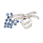 Brooch in 750 white gold with brilliants and sapphires, lying frontally