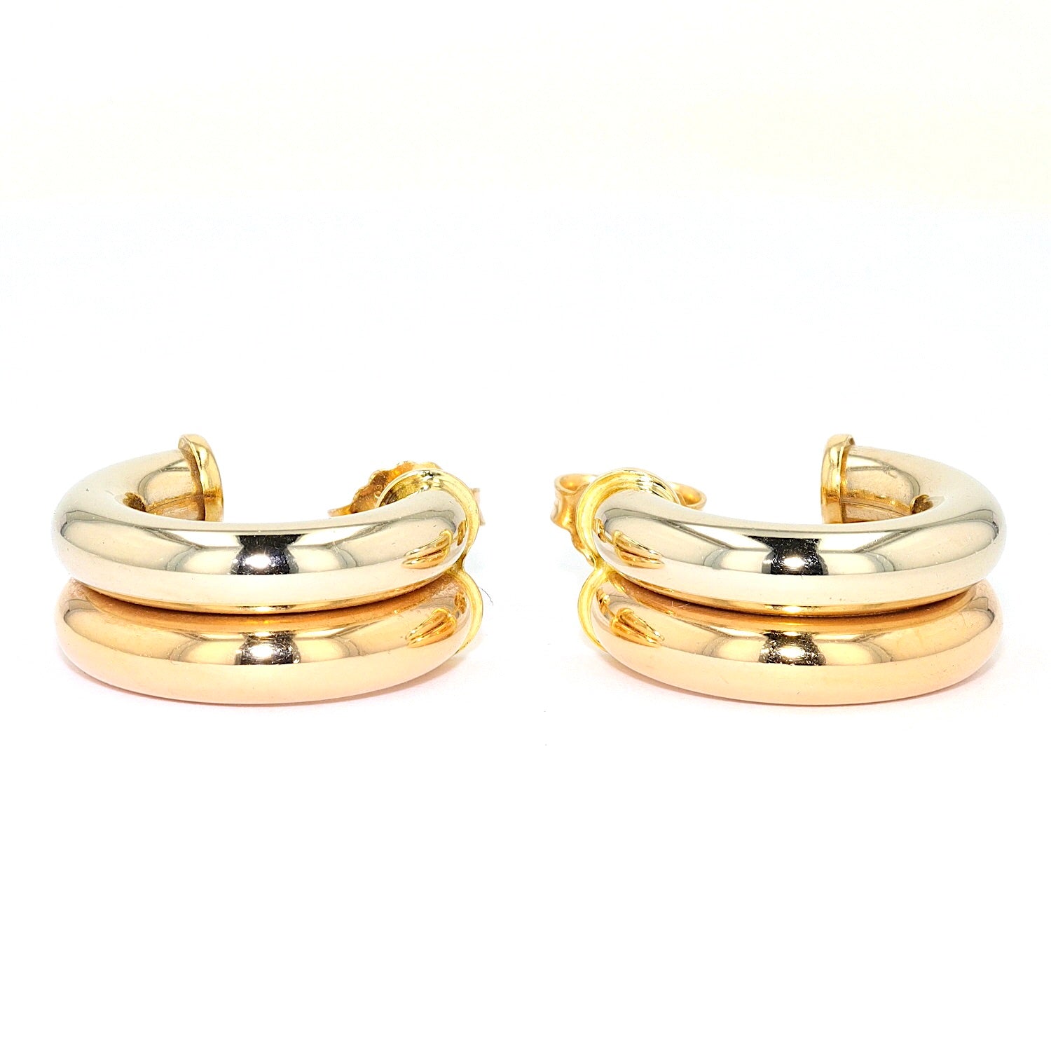 1 pair of half hoops in 750 bicolor gold, lying frontal