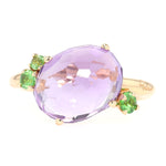 Pomellato ring in 750 rose gold with an amethyst and tsavorite, lying frontally