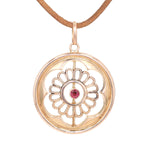 Art Nouveau pendant in 333 rose gold with a garnet, hanging frontally