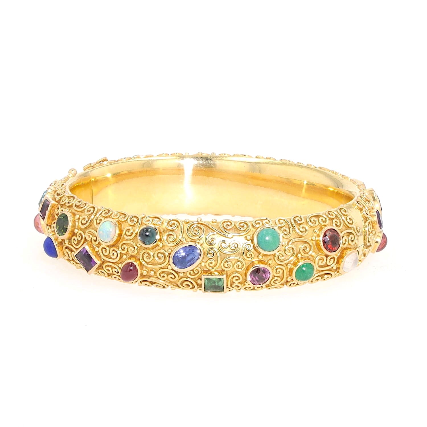 Bangle by Eugen Hirner in 750 yellow gold with various colorful gemstones, turned horizontally to the left