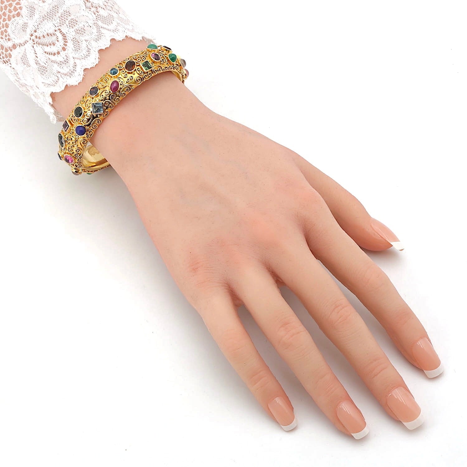 Bracelet by Eugen Hirner in 750 yellow gold with various colorful gemstones, on the arm