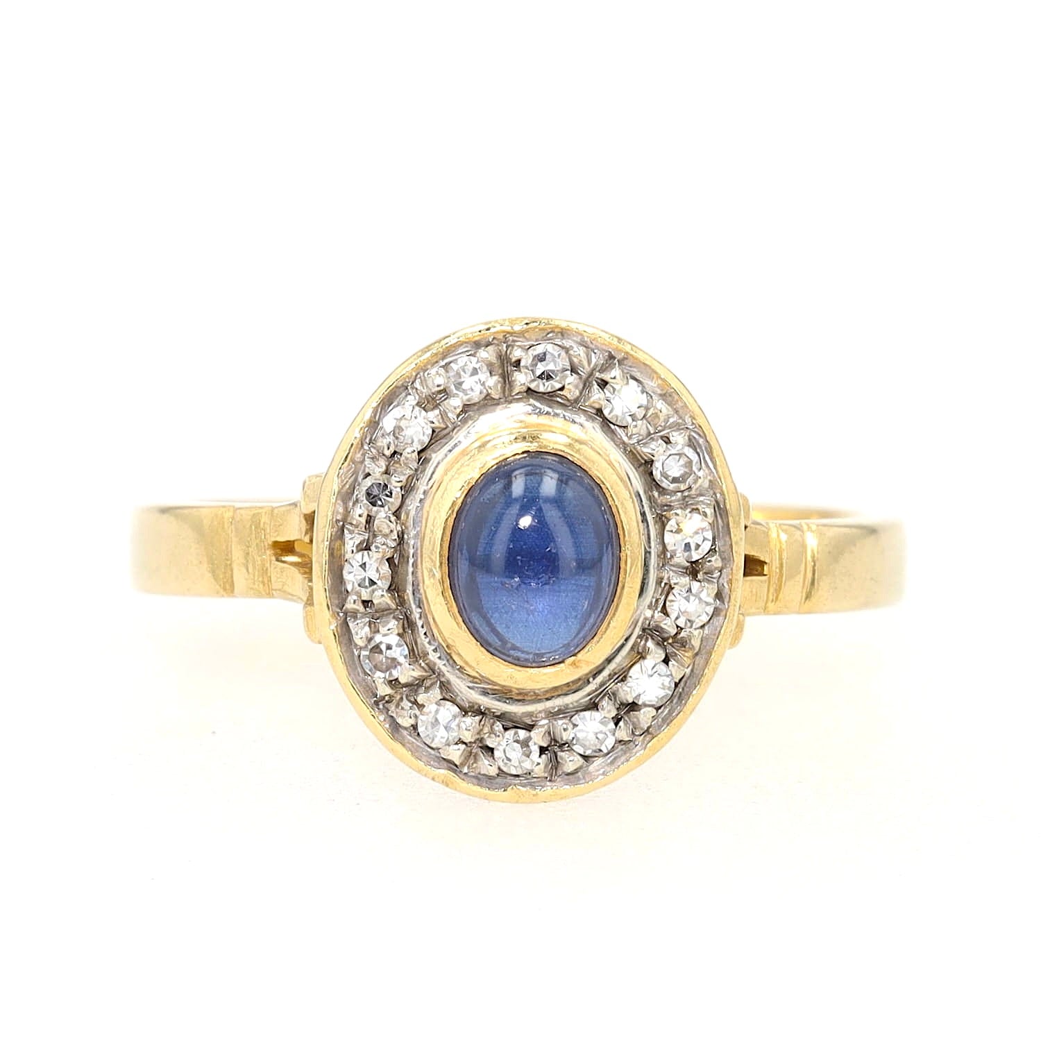 Ring in 750 yellow gold with a blue sapphire cabochon and diamonds, lying frontally