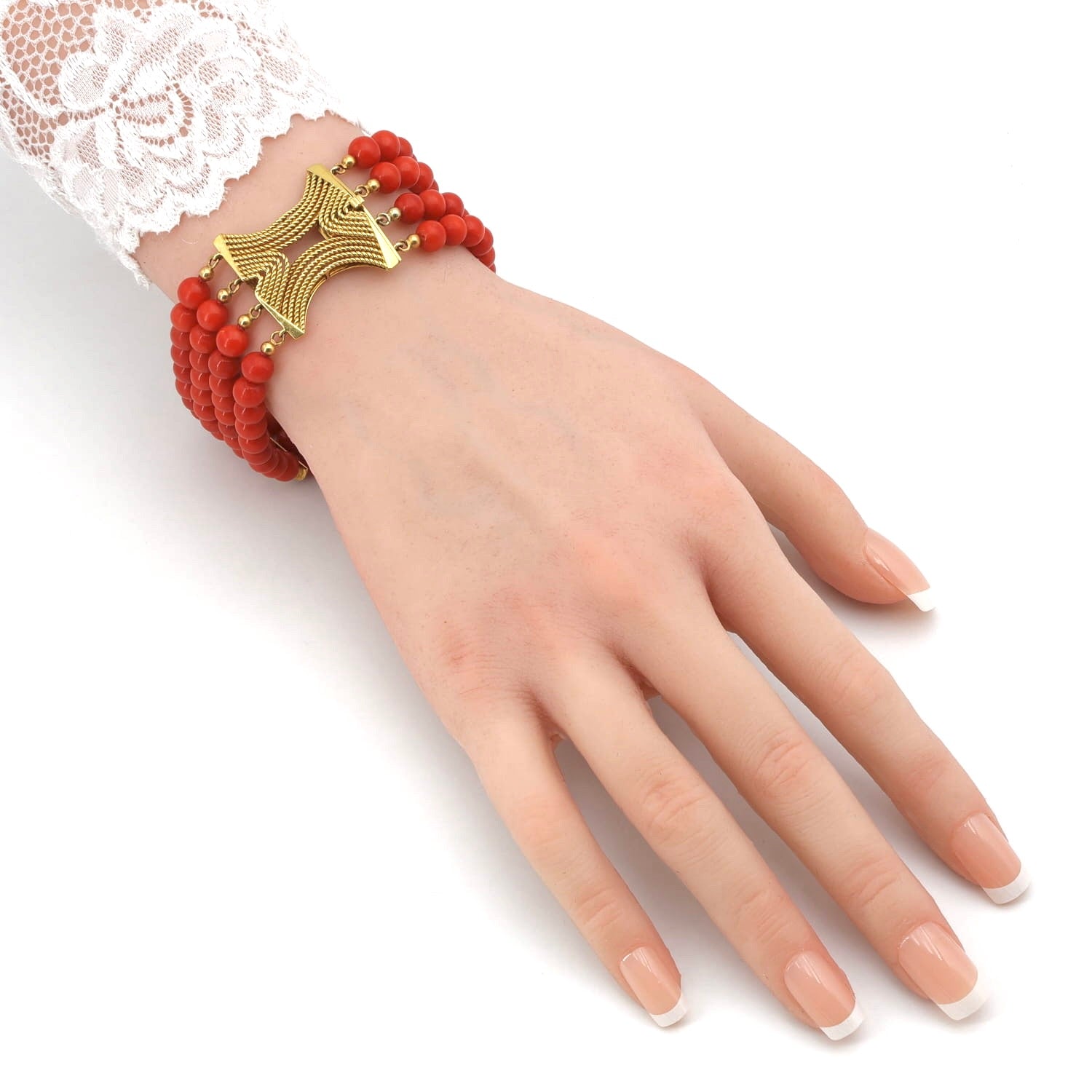 Four-row vintage red coral bracelet with a 750 yellow gold clasp, on the arm