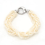 Bracelet with 8 intertwined rows of cultured pearls and a silver lock, horizontal top view